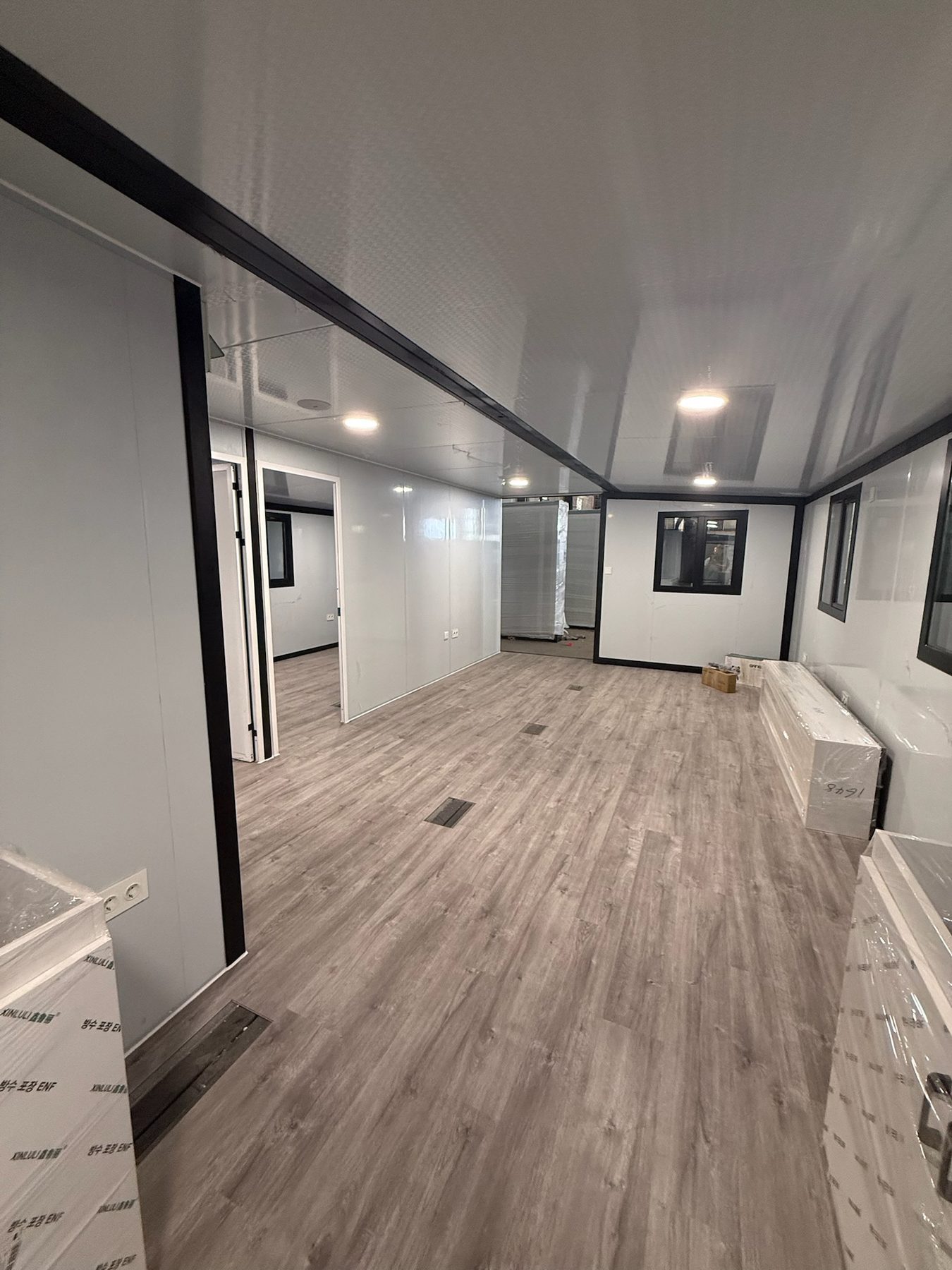 Open-plan modular house interior with resilient flooring